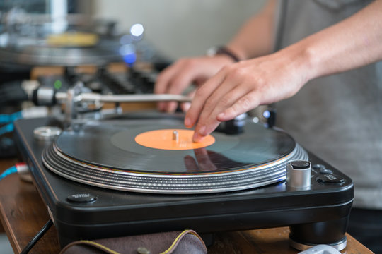 Dj play music at hip hop party.Turntable vinyl record player,analog sound technology for disc jockey to scratch vinyl records and mix tracks