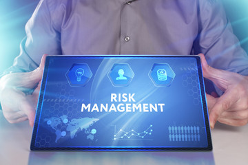 Business, Technology, Internet and network concept. Young businessman working on a virtual screen of the future and sees the inscription: Risk management