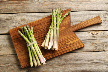 Fresh green asparagus on a grey wooden table