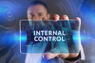 Business, Technology, Internet and network concept. Young businessman working on a virtual screen of the future and sees the inscription: Internal control