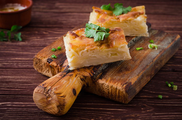 Traditional Georgian cheese layer pie Achma on wooden background. Selective focus