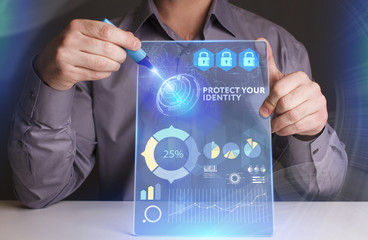 Business, Technology, Internet and network concept. Young businessman working on a virtual screen of the future and sees the inscription: Protect your identity