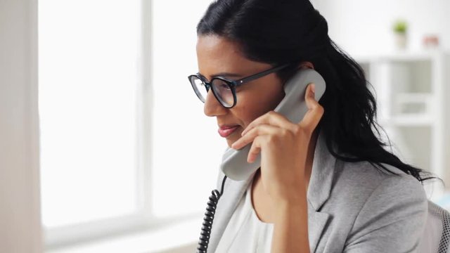 businesswoman calling on phone at office