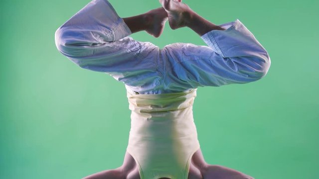 Caucasian man doing yoga with beer headstand pose