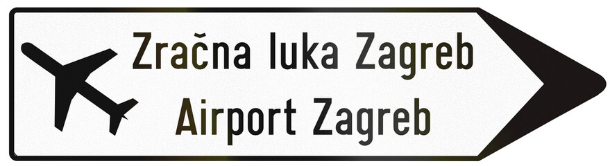 Fototapeta na wymiar Signpost type direction road sign used in Croatia with Airport Zagred written in Croatian and English