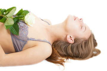 Obraz na płótnie Canvas lying girl wearing underwear with white rose, isolated on white background