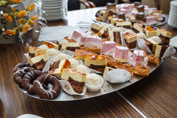 Naklejka na ściany i meble Different delicious desserts and cakes on table