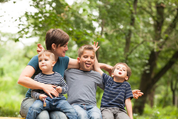 Fototapeta premium Mother with sons outdoors