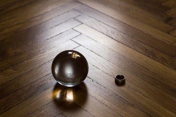 Crystal fortune-telling ball placed on wooden floor