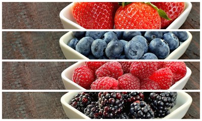 Mix of strawberries, blueberries, blackberries and raspberries fruit on wood table. Forest fruit in white idaeus. Delicious fresh berries.