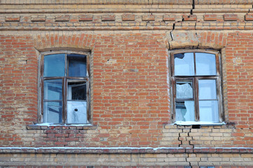 The old broken windows in an abandoned house