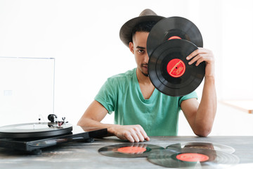 African man hiding behind the records