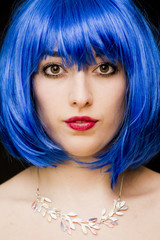 Beauty Woman With Blue Wig And Sunglasses Over Black Background