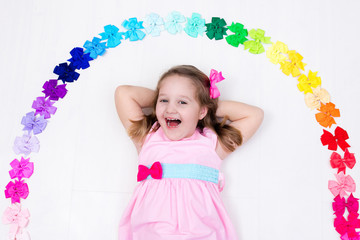 Little girl with colorful bow. Hair accessory