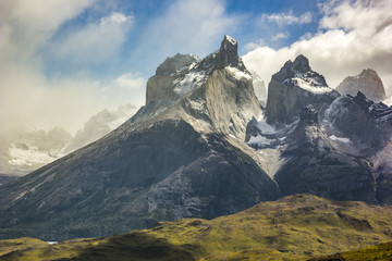 mountains of patagonia in haze at sunrise near blue lake