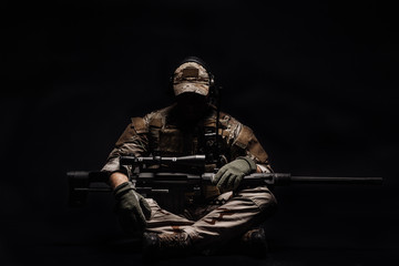 Portrait soldier or private military contractor holding sniper rifle. war, army, weapon, technology...