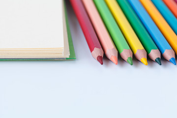 Set colored pencils on paper