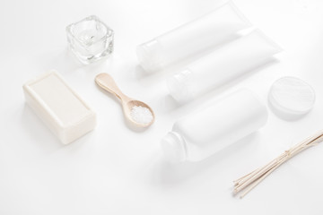 body care concept with white set of cosmetics woman desk top view