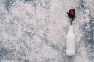 White bottle with rose 