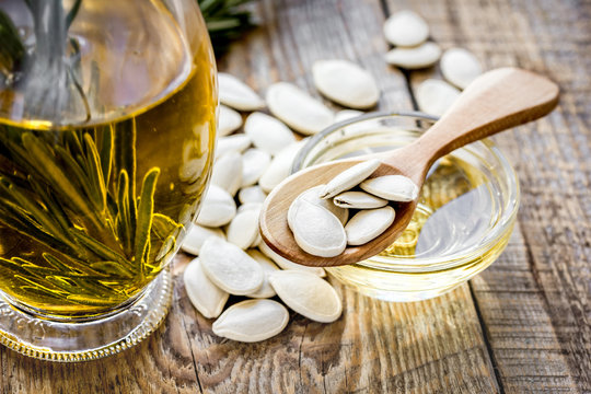 natural oils concept with pumpkin seeds on table background