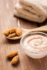 natural scrub with almond on wooden table background