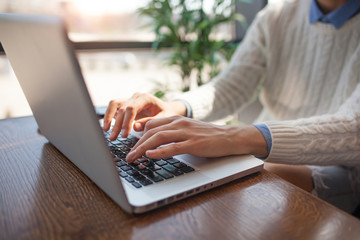 Business man using laptop computer. Male hand typing on laptop keyboard