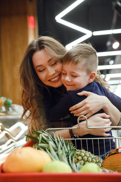 Vertical Image Of Woman With Child In Supermarket