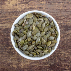 pumpkin seeds / Porcelain bowl with green pumpkin seeds 