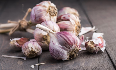 Organic garlic. Garlic press. Violet garlic.Wooden board.