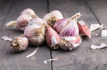 Organic garlic. Garlic press. Violet garlic.Wooden board.