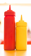 Close up on diner style ketchup and mustard bottles