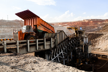 Obraz premium Part of a pit with big mining truck working