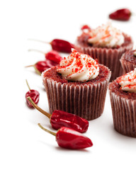 Chocolate  cupcakes with red hot chili pepper isolated on white