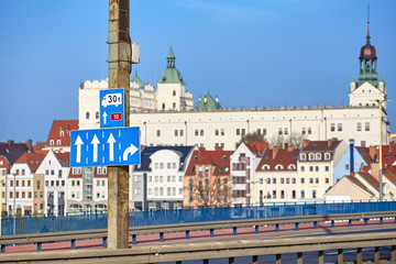 Street signs by the Castle route, main Szczecin city entrance highway with old town in distance,...