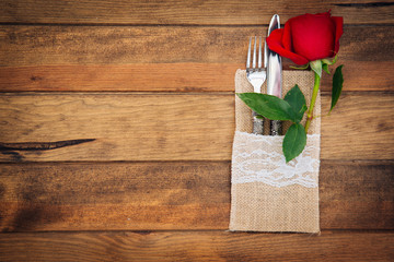 Romantic rustic table setting over wooden background 