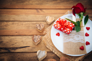 Romantic rustic table setting over wooden background 