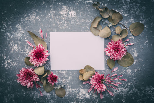  Paper blank and pink flowers on white background. Mockup with flowers. Flat lay, top view