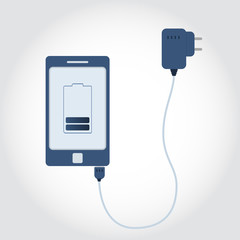 Phone plugged on charger. Battery symbol on monitor showing charge level.