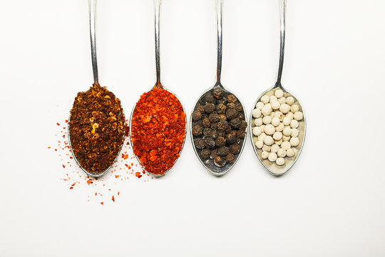 Spicy seasoning. Thai spices on spoon. Pepper and caryenne pepper.