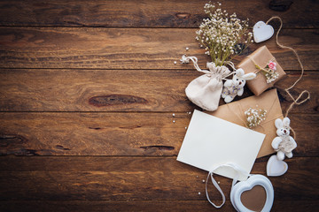 Vintage craft envelope with decorations over wooden background. Copy space. Wedding concept 