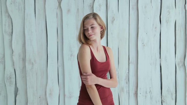 Portrait of pretty and sensual teen girl without makeup. White wooden background. Natural beauty concept