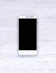 Single white smartphone on grey background. Top view. Flat lay