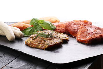 Selection of marinaded meat for grilling and sausages