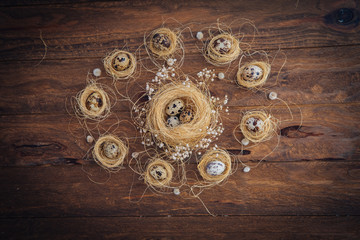 Small quail Easter eggs over wooden background. Rustic decorations 