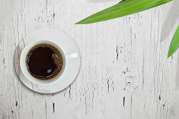 Coffee on the antique wooden table with plant beside, free space for text, icons, etc