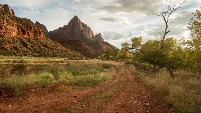 Time lapse moving across dirt road looking at mountain