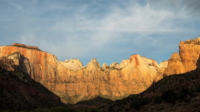 Time lapse of cliffs lighting up at sunrise in Zion National Park