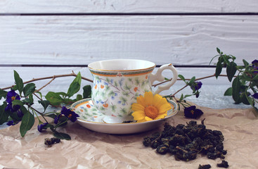 Cup of green tea Milk oolong and scattered cones for brewing on the wooden table