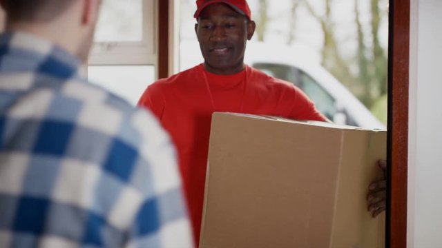  Delivery driver bringing package to customer's door & getting signature