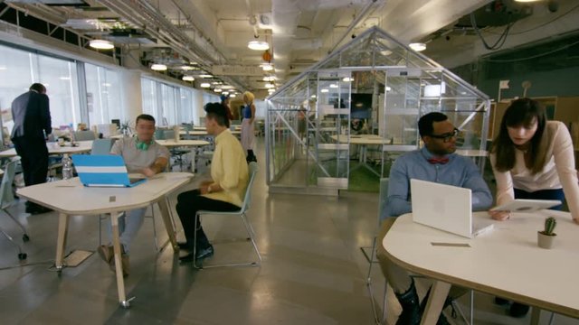  Time lapse of busy creative business team working hard in trendy office